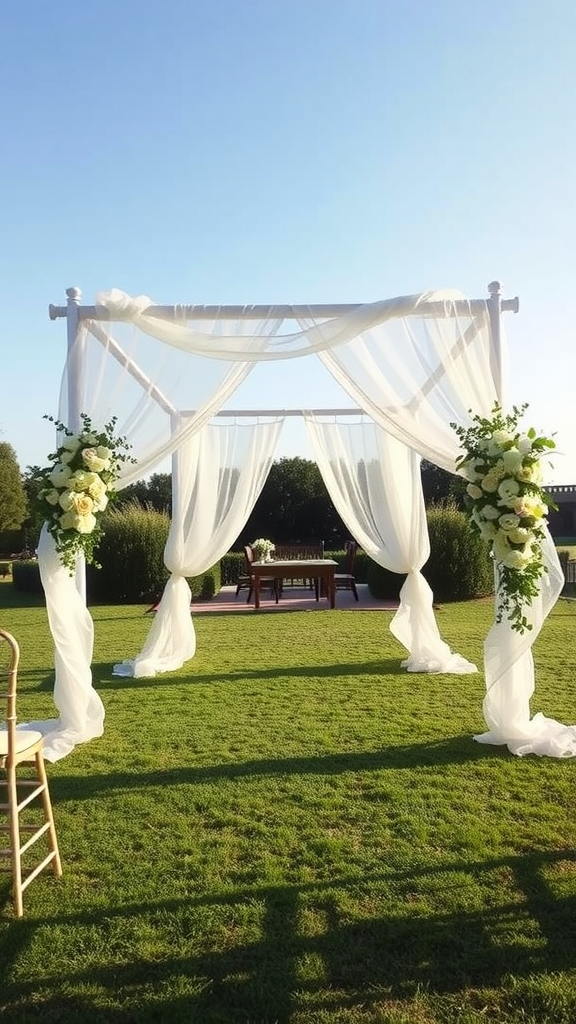 An elegant outdoor wedding arch draped with white fabric and decorated with flowers.