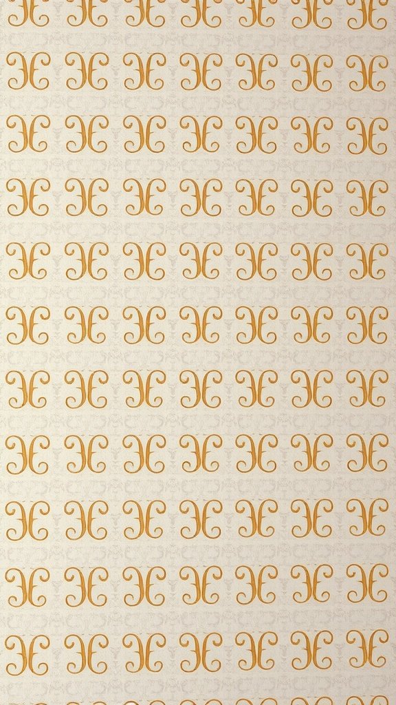 Classic monogrammed wallpaper pattern in gold